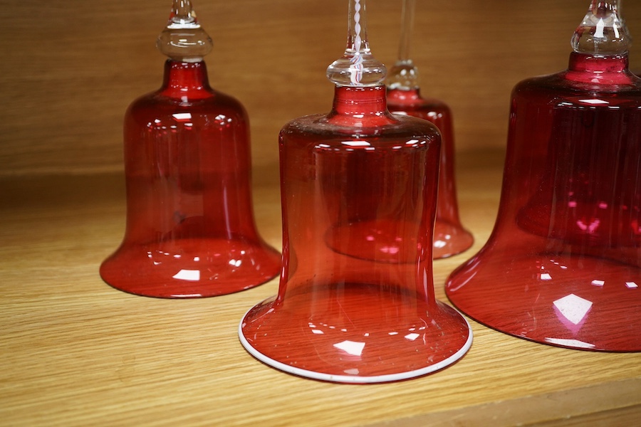 Seven Victorian cranberry glass bells, one with patriotic opaque twist handle, largest 30cm high. Condition - fair/good